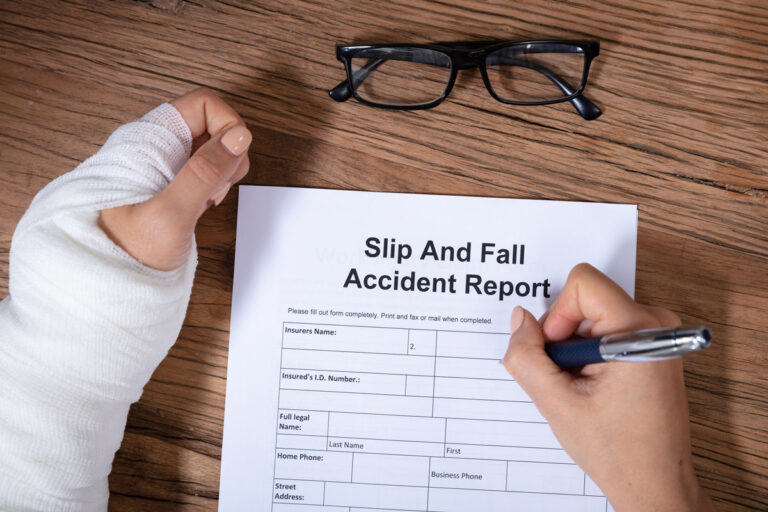 Image of an injured person filling out a slip and fall accident report.